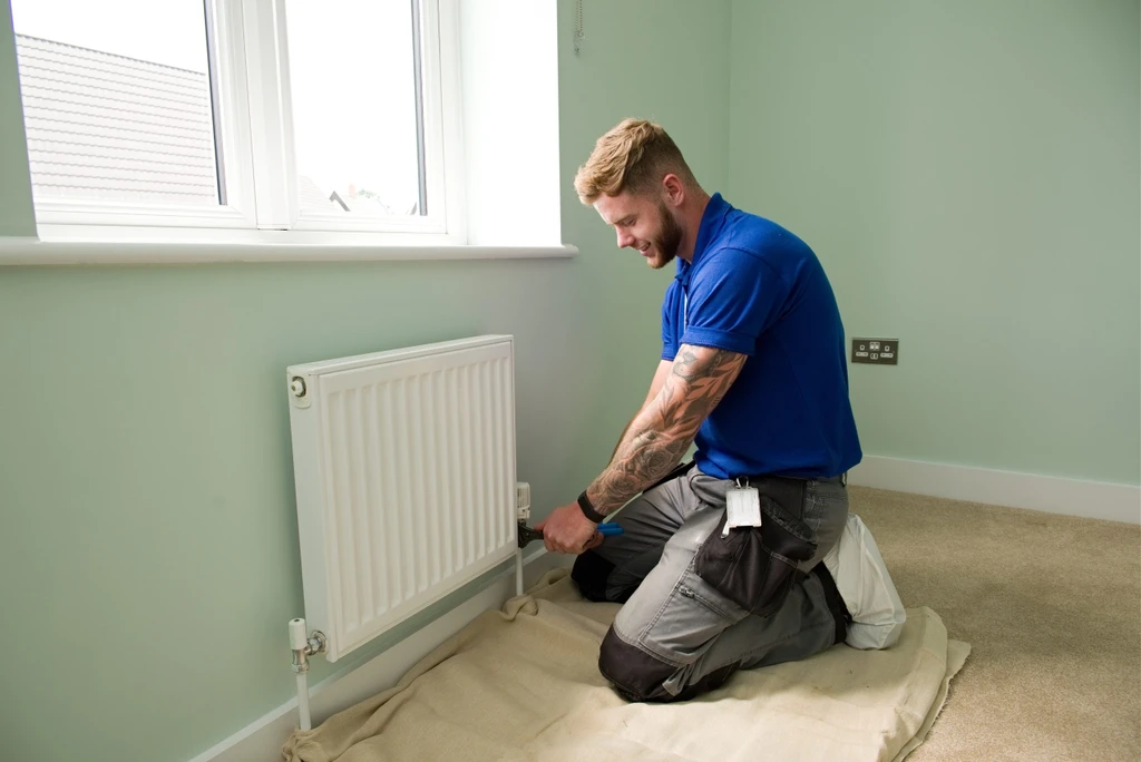Engineer fixing radiator