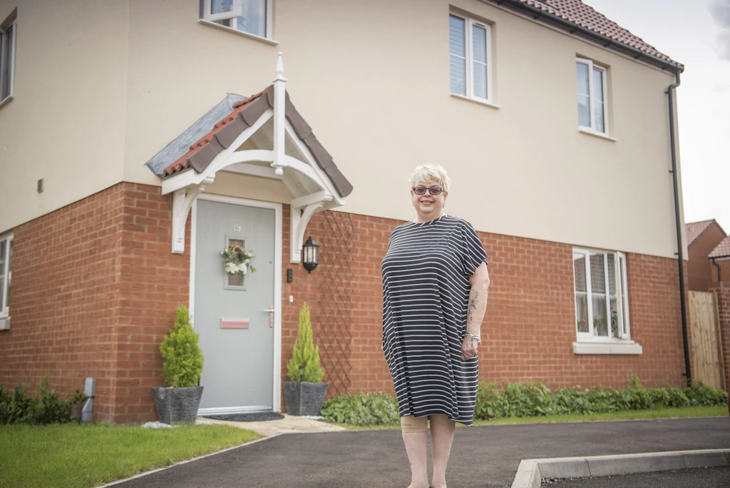 Dana standing outside her house