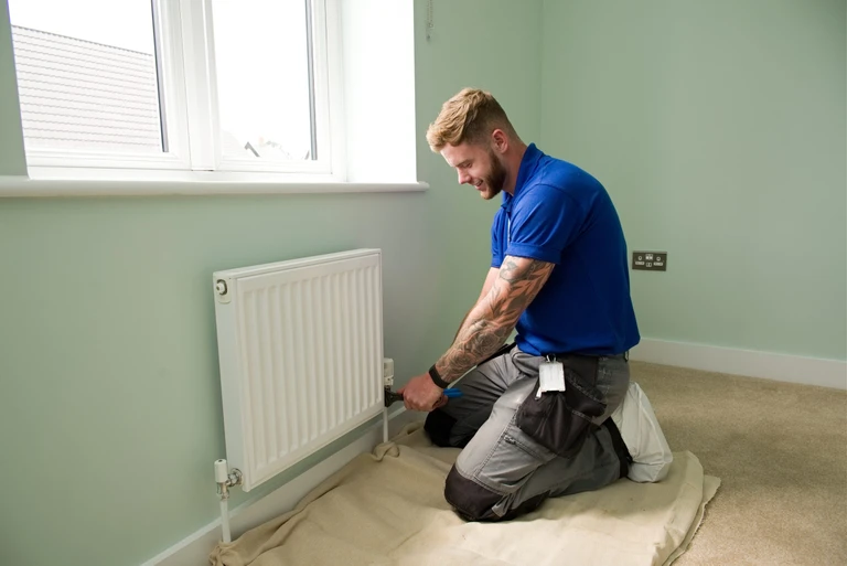 Engineer fixing radiator