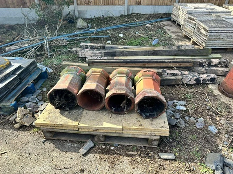 Old chimneys stacked on top of paving slabs