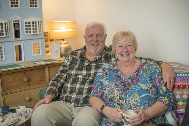 Jan and Peter having a cuppa on the sofa