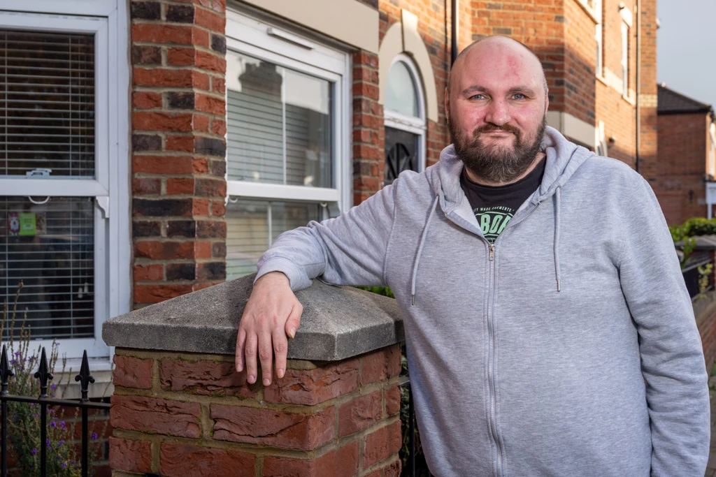 Supported customer Carl, outside his home