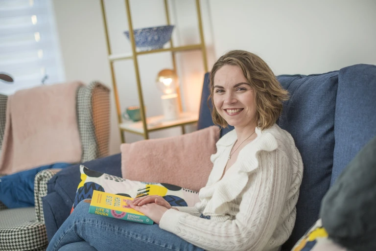 Keira relaxing on her sofa in her home in Hackleton, Northants