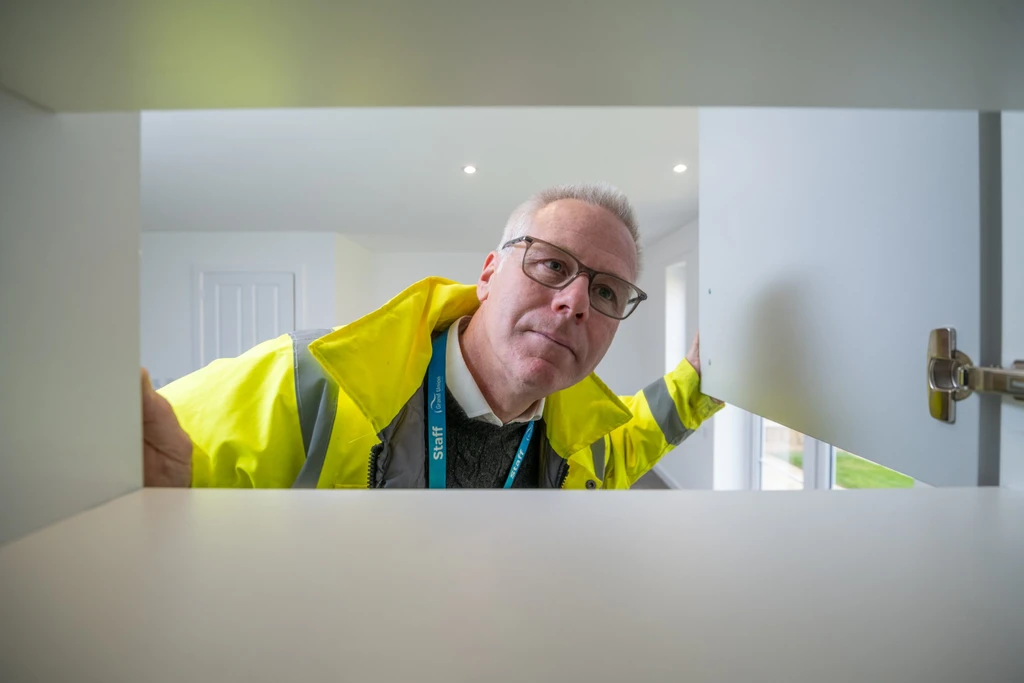 Stuart inspects kitchen cupboards