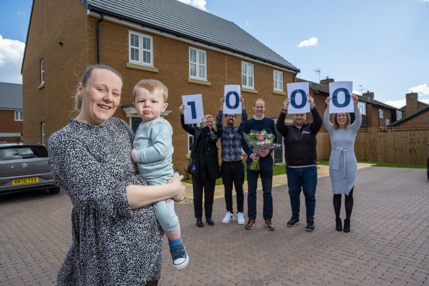 Alice and her son Oscar are presented with flowers by Grand Union staff to celebrate their home in Shefford being Grand Union's 1000th shared ownership property