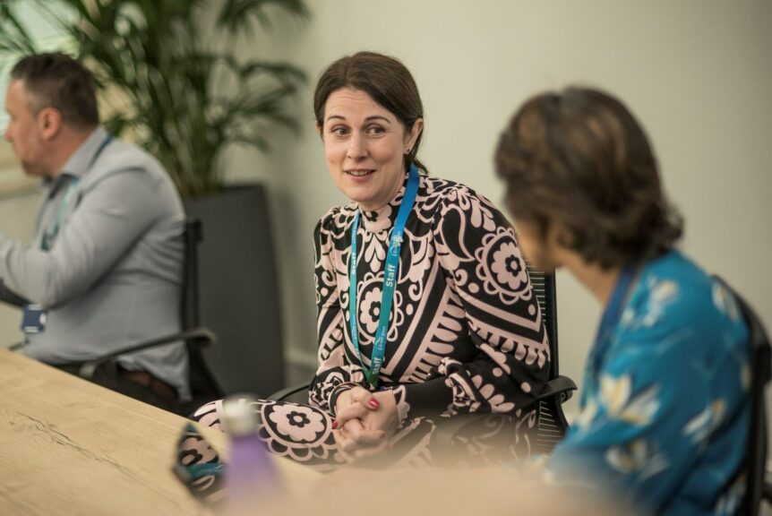 Naomi Sweeting, Director of Customer Experience, in a meeting with colleagues
