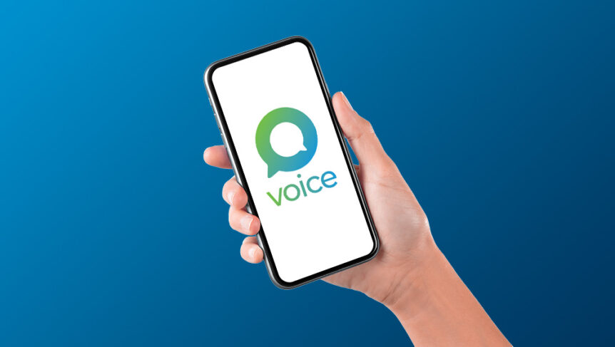 Hand holding phone with Voice logo on the screen