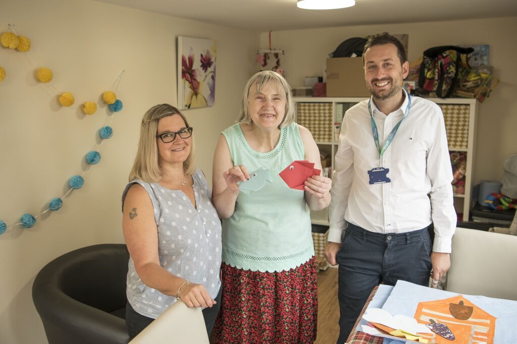 Scheme manager Kate, customer Valerie and Chris in the activity room
